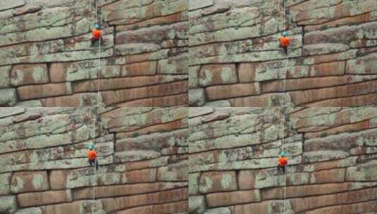 一名男子从岩石上爬下来高清在线视频素材下载