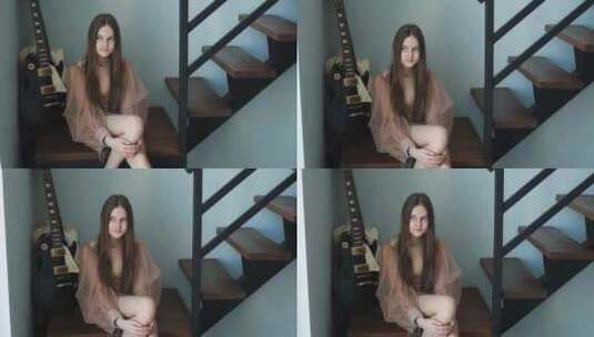时髦的女孩坐在家里的楼梯上高清在线视频素材下载