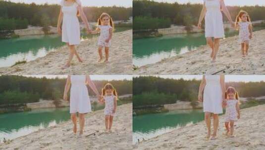 母亲和女儿在湖边散步高清在线视频素材下载