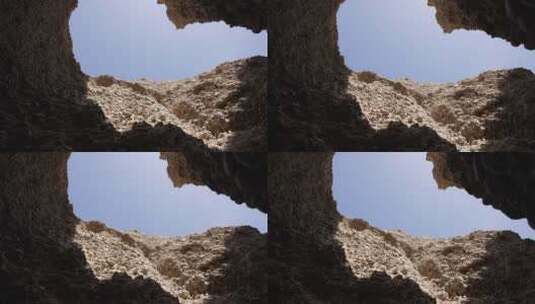 峡谷岩壁下山洞内仰拍高清在线视频素材下载