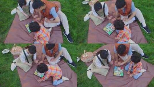 一家三口坐在野餐垫开心玩游戏高清在线视频素材下载