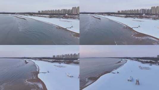 沿海城市被雪覆盖的沙滩及高楼景象高清在线视频素材下载