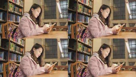 女留学生在图书馆使用电子设备学习高清在线视频素材下载