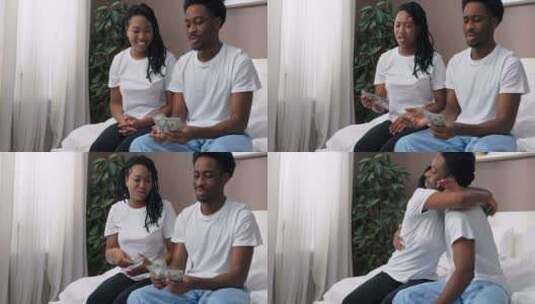 快乐快乐的美国黑人夫妇深色皮肤的家庭坐在高清在线视频素材下载