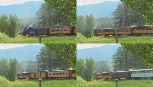 一列蒸汽火车穿过山脉的乡村高清在线视频素材下载