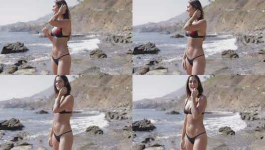 穿着泳衣站在海滩上的女人高清在线视频素材下载