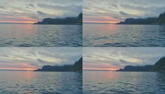 沿着山区海岸的日落时分的海上天桥高清在线视频素材下载