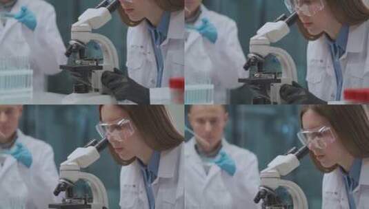 科学家使用显微镜下观察化学反应高清在线视频素材下载
