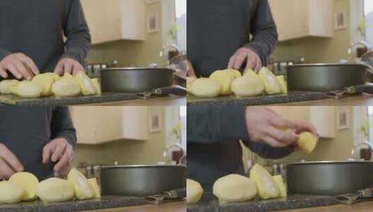 男人把土豆放在厨房的锅里高清在线视频素材下载