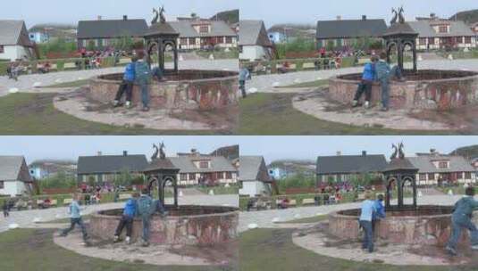 两个小男孩在喷泉旁边玩耍高清在线视频素材下载
