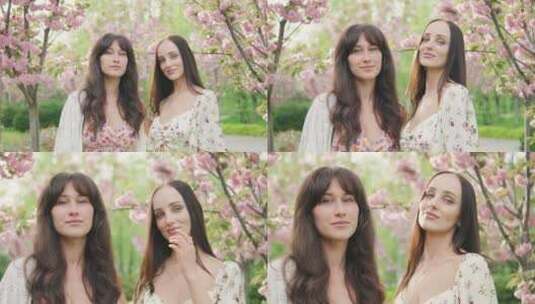 两位美丽女友在盛开的樱花树旁微笑着看着相高清在线视频素材下载