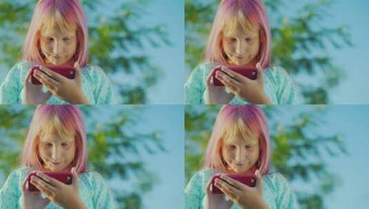一个粉色头发的女孩正在使用粉色智能手机高清在线视频素材下载