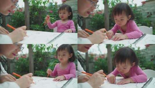 小女孩和妈妈在院子里一起写字画画学习高清在线视频素材下载