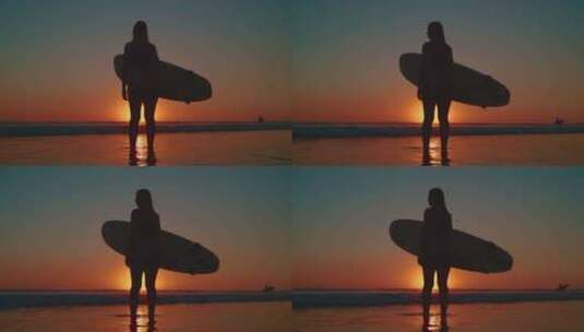 海边夕阳下拿着冲浪板的女孩高清在线视频素材下载