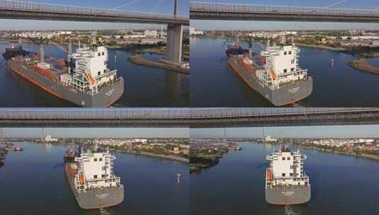 城市航拍货轮穿越大桥进入港口高清在线视频素材下载