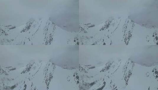 航拍四川阿坝松潘岷山山脉云雾中的雪山高清在线视频素材下载