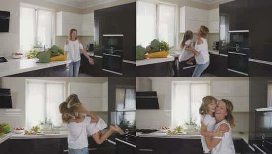 母亲抱起女儿在厨房转圈高清在线视频素材下载