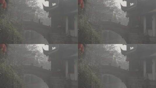 在中式拱桥上行走的男子高清在线视频素材下载