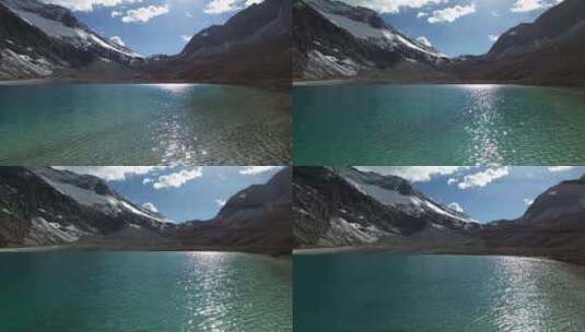 亚丁雪山小湖 湖面飞掠航拍高清在线视频素材下载