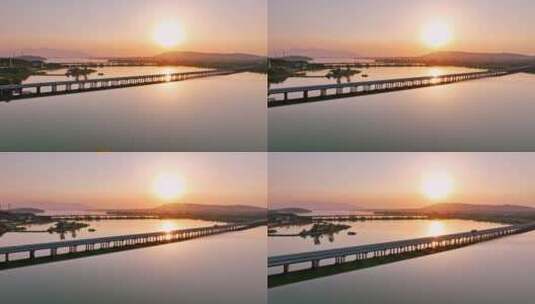 航拍夕阳下穿过鄱阳湖的乡间高速公路高清在线视频素材下载