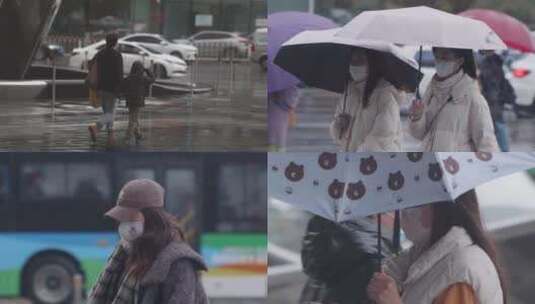雨天行人撑伞过马路 寒冷降温相互取暖高清在线视频素材下载