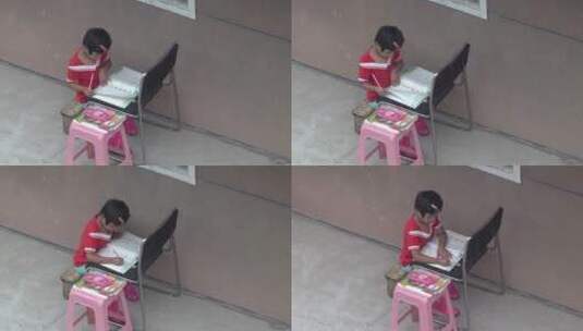 下雨天在屋檐下学习写作业的小女孩高清在线视频素材下载