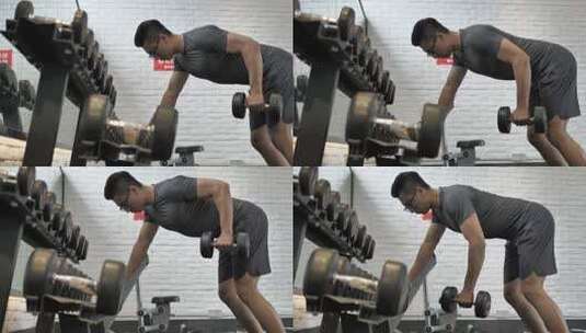 男子在健身房使用哑铃锻炼背部肌肉高清在线视频素材下载