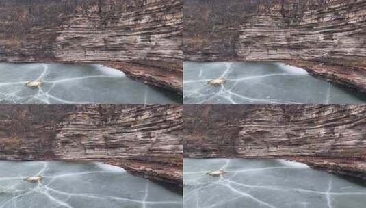 冬季山谷结冰湖面与岩壁景观高清在线视频素材下载