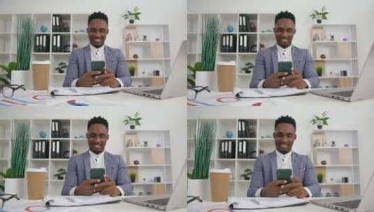 男人坐在办公室看着手机微笑高清在线视频素材下载