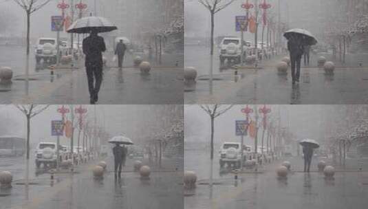 鹅毛大雪街道上的行人打着伞高清在线视频素材下载