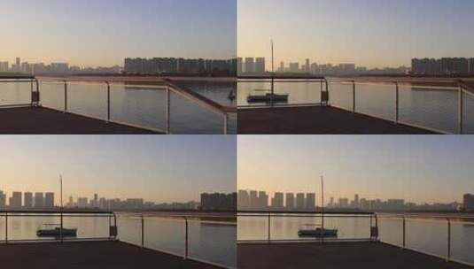 日出清晨宁静海湾栈道和城市建筑高清在线视频素材下载