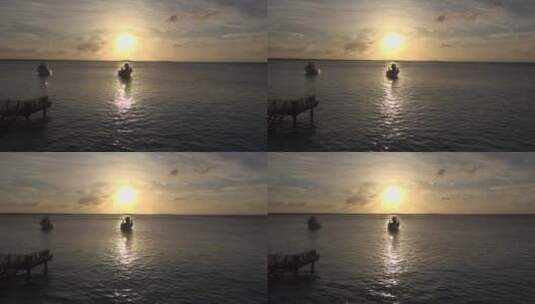 夕阳下的小船在海面慢慢游行高清在线视频素材下载