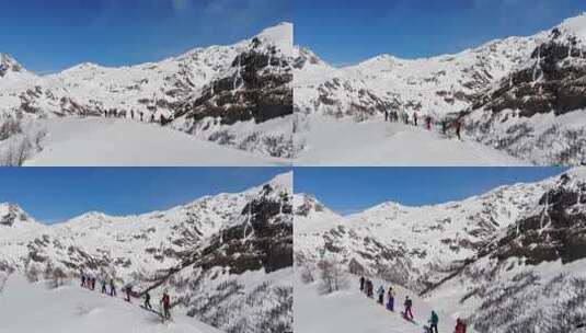 一组滑雪旅游在皮肤上坡排成一行。在大山里滑雪旅游高清在线视频素材下载