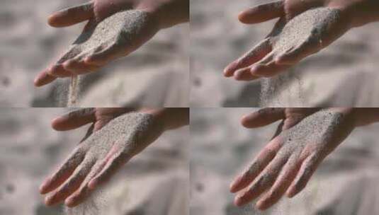 沙子从手中滑落特写高清在线视频素材下载
