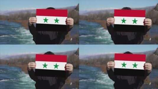 手持叙利亚国旗旗帜的人高清在线视频素材下载