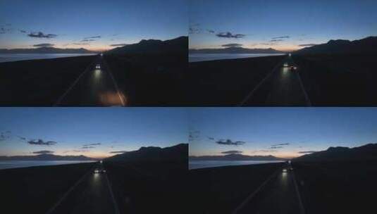 黄昏时分航拍汽车行驶在赛里木湖环湖公路上高清在线视频素材下载