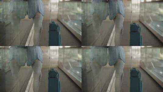 一个拖着行李箱在电梯上行走的女人高清在线视频素材下载