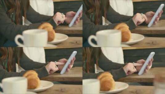 女子在咖啡厅里玩手机高清在线视频素材下载