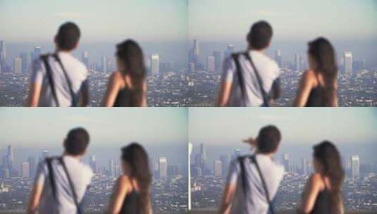 男人和女人站在山顶眺望整个城市高清在线视频素材下载