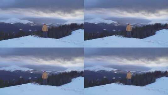 旅行者站在雪山山顶高清在线视频素材下载