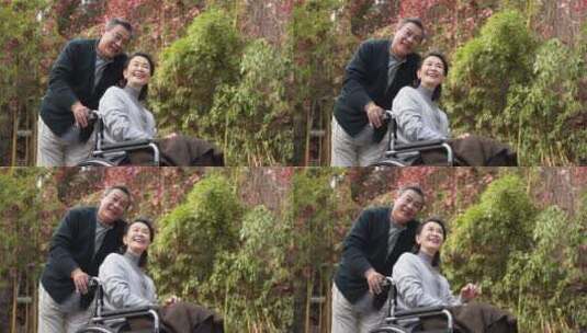 老年男性推着坐轮椅的老伴高清在线视频素材下载