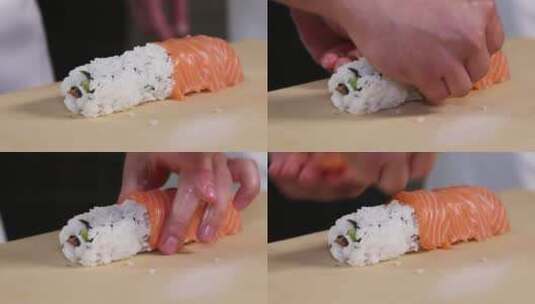 厨师的手卷寿司卷。寿司制作过程。卷寿司卷高清在线视频素材下载
