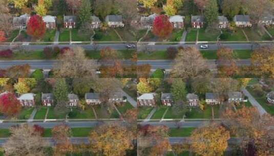 空中卡车拍摄的越野车在秋叶中穿过美国郊区城镇。高清在线视频素材下载