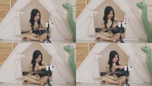 女孩在手机前弹尤克里里高清在线视频素材下载