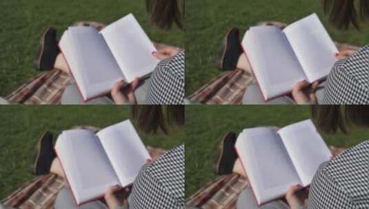 年轻女子在公园里看书高清在线视频素材下载