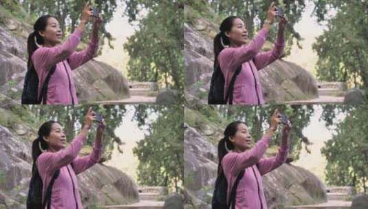 中国人女人树林徒步旅游拍照视频对话看风景高清在线视频素材下载