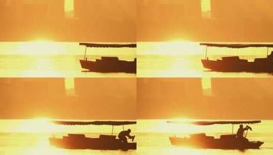 手摇游船泛舟金色夕阳返照下湖面高清在线视频素材下载
