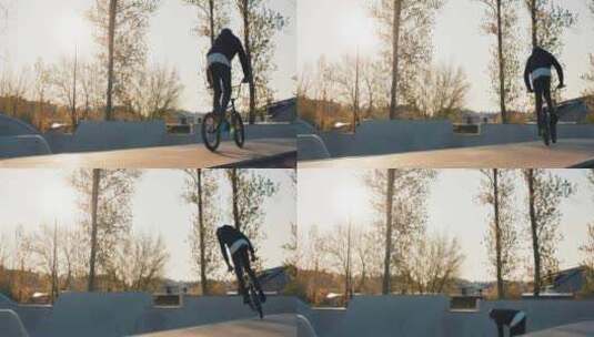 一个年轻人在坡道上的滑板公园拿着一辆Bmx自行车高清在线视频素材下载