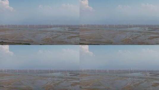 大海海边沙滩风车自然风光蓝天白云航拍高清在线视频素材下载