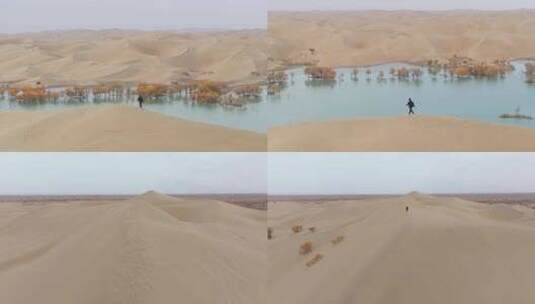 航拍男人走在秋天新疆葫芦岛的沙丘上高清在线视频素材下载